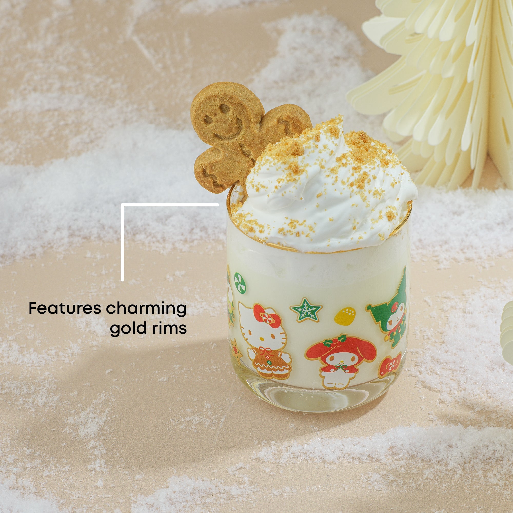 Close-up of Hello Kitty glass cup with gold rim and gingerbread outfit