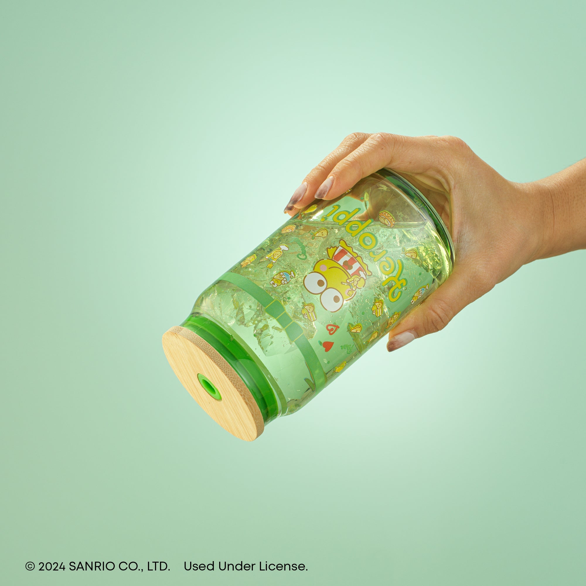 Keroppi glass tumbler with straw on a wooden table, showcasing its kawaii design