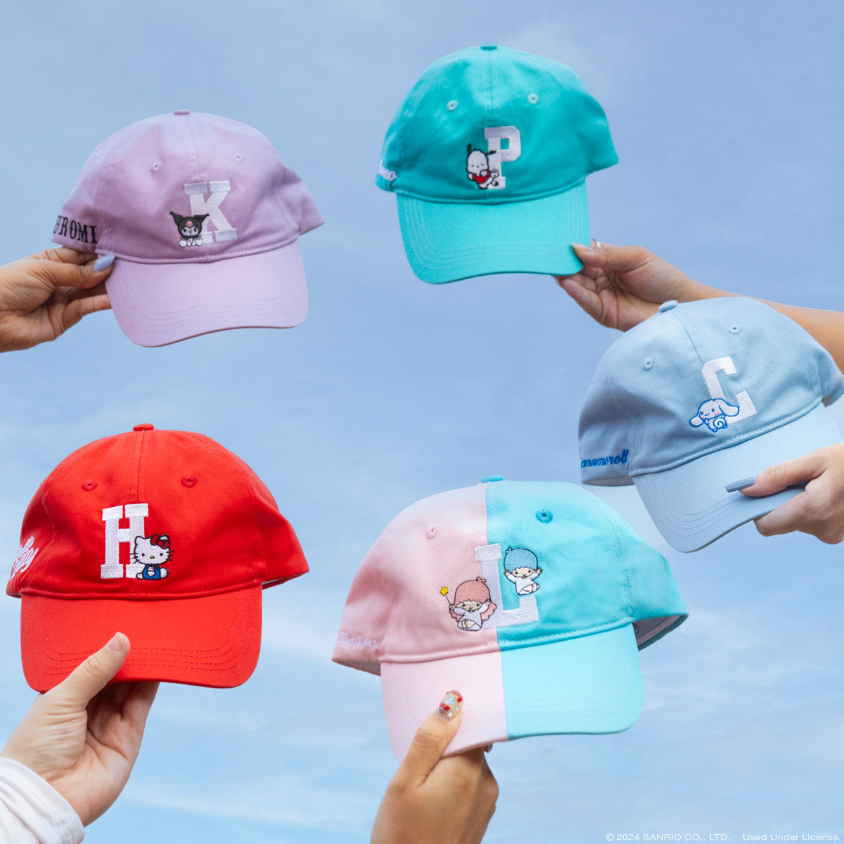 Close-up of embroidered hello kitty with hat design on light blue fabric