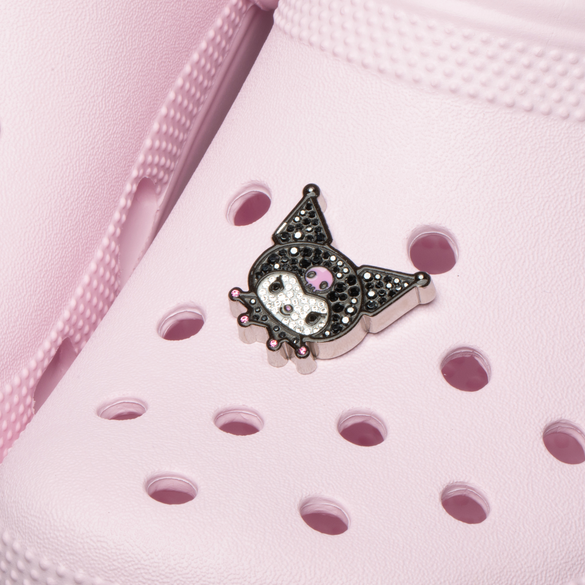 Kuromi Jibbitz charm displayed on Crocs Classic Clog with sunlight reflecting off Swarovski crystals