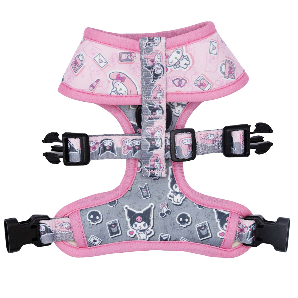 Dog wearing a reversible dog harness with handle and My Melody & Kuromi print during a walk in the park