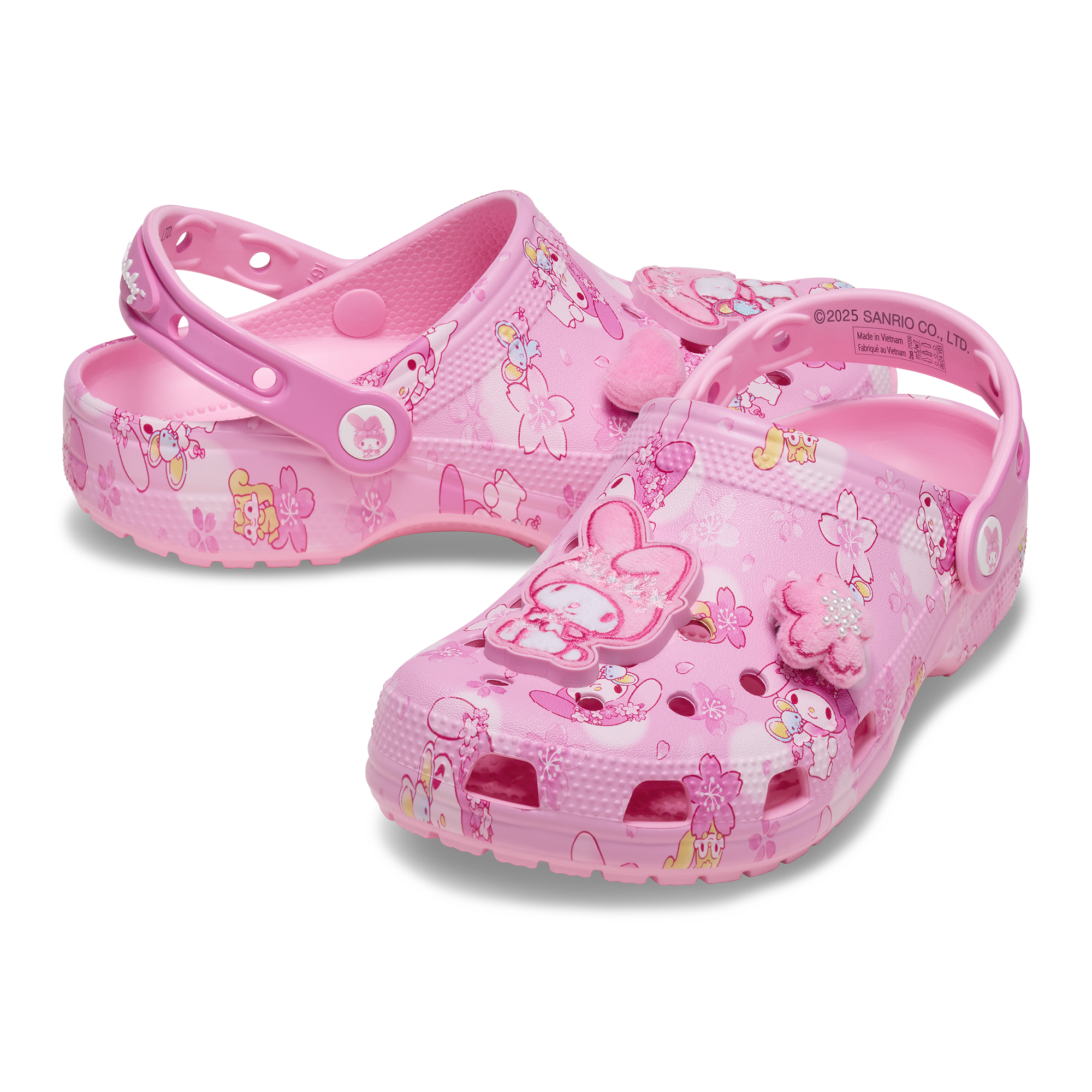 My Melody x Crocs clogs displayed on a pink background, showcasing Jibbitz charms. My Melody x Crocs clogs displayed on a pink background, showcasing Jibbitz charms.