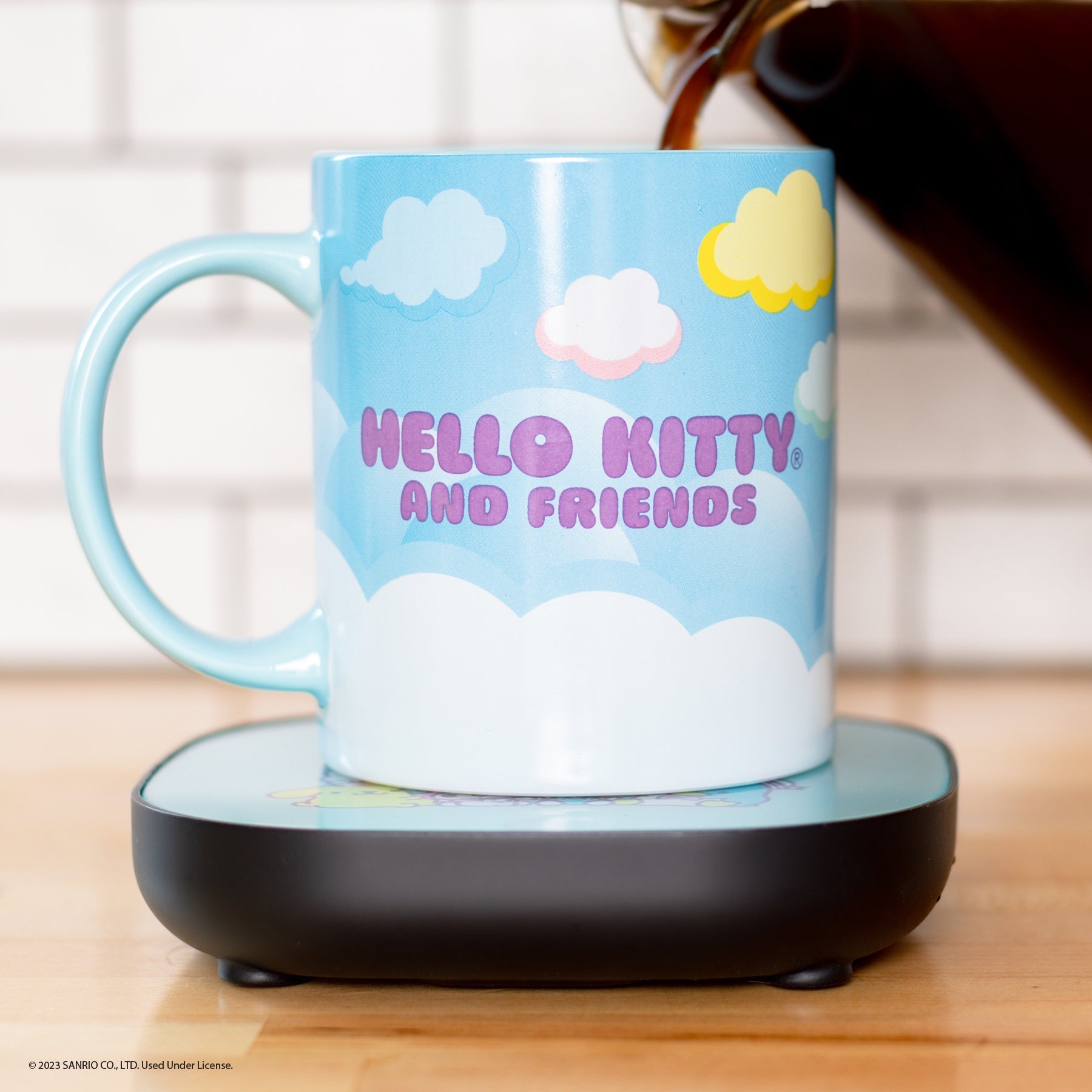 Side-by-side view of the ceramic mug and warmer, showcasing playful Sanrio designs.