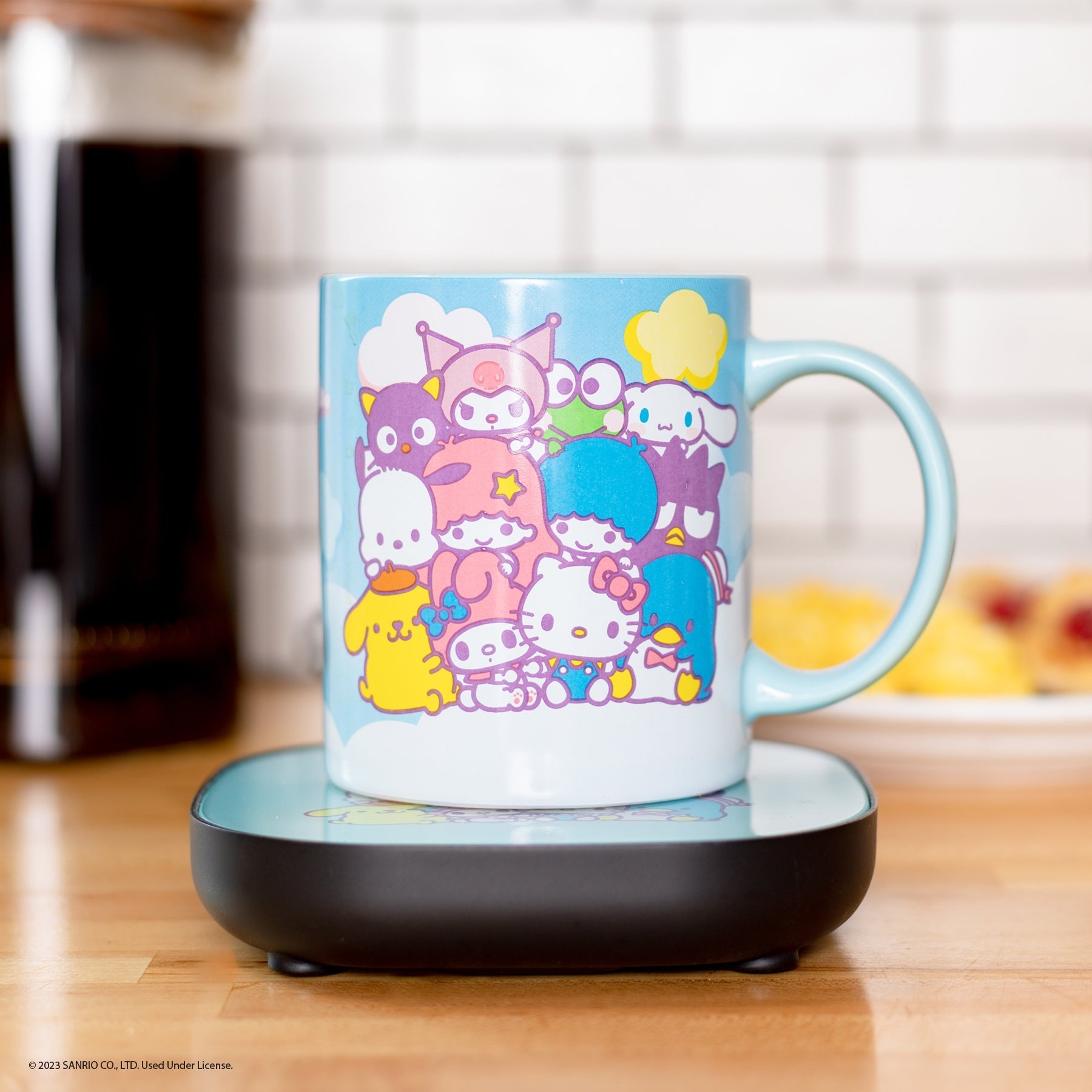 Close-up of Hello Kitty coffee mug with Sanrio characters, filled with steaming coffee.
