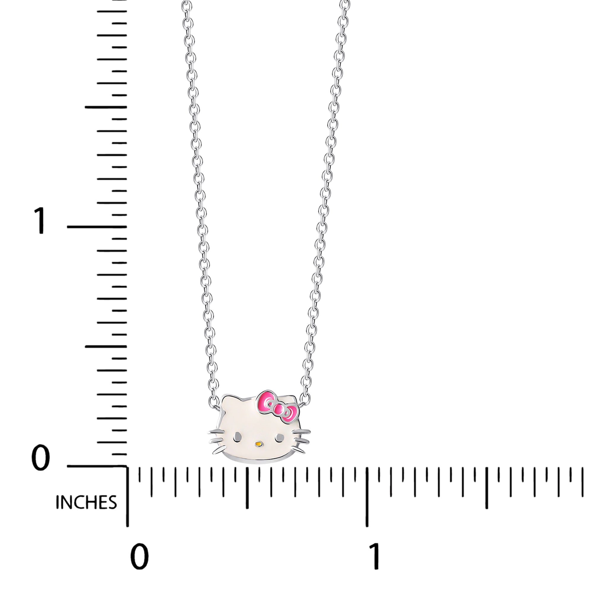 The Hello Kitty pendant being held by a hand, showcasing its enamel details.