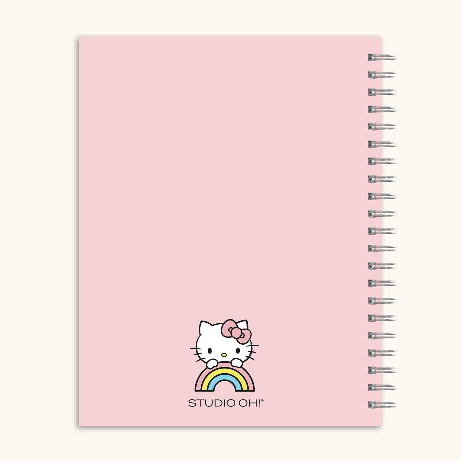 Close-up of spiral bound notebook open with reminder stickers and writing in progress