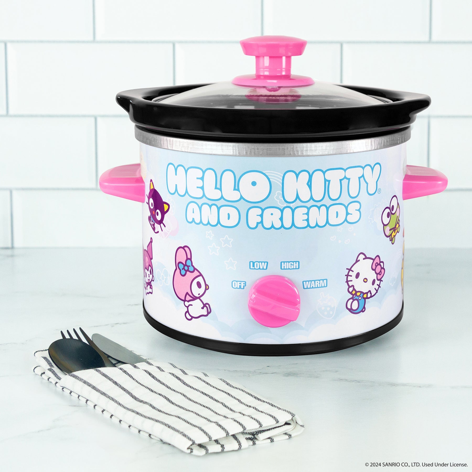 Removable stoneware insert of Hello Kitty slow cooker being cleaned