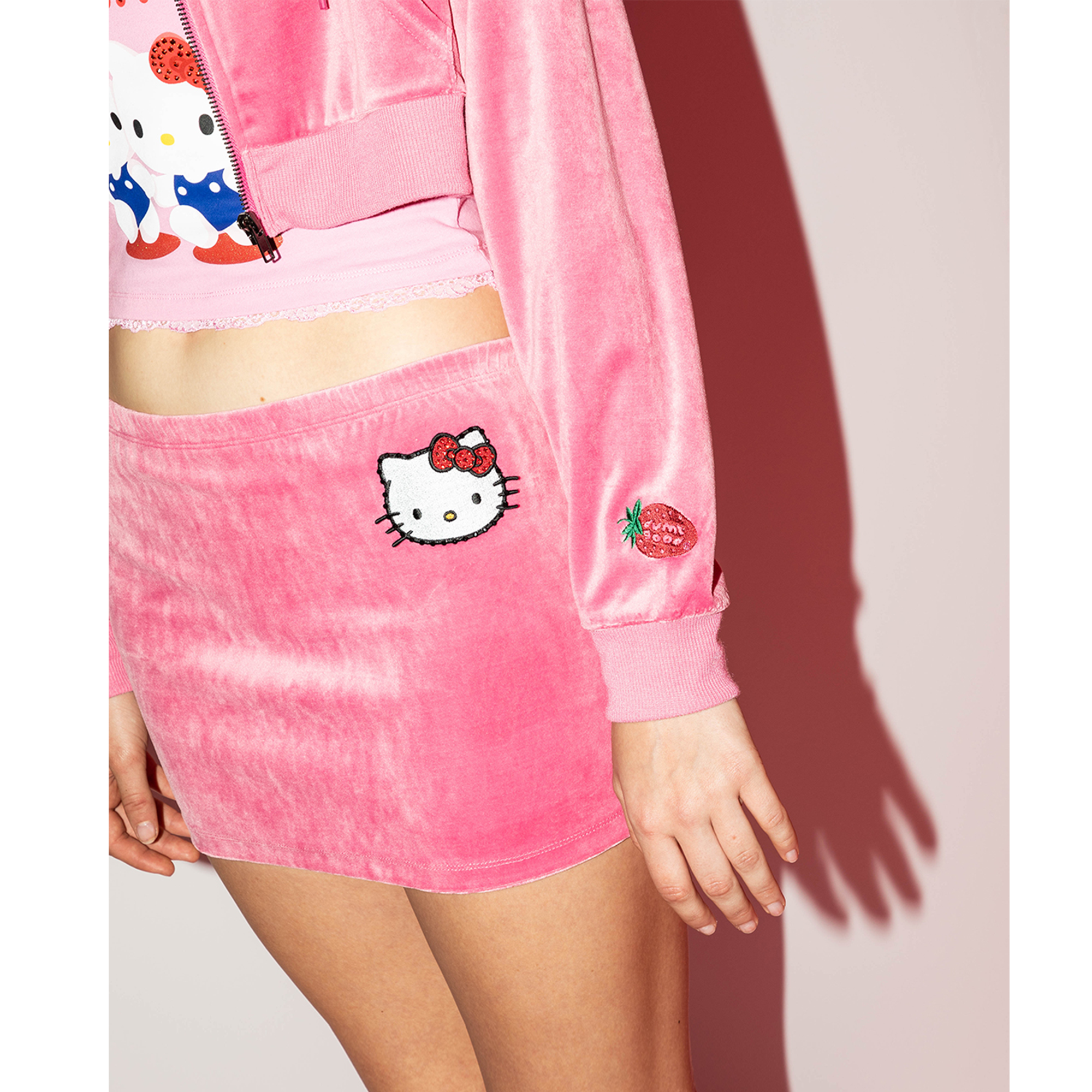 Model wearing the Hello Kitty skirt with a cropped hoodie for a casual look