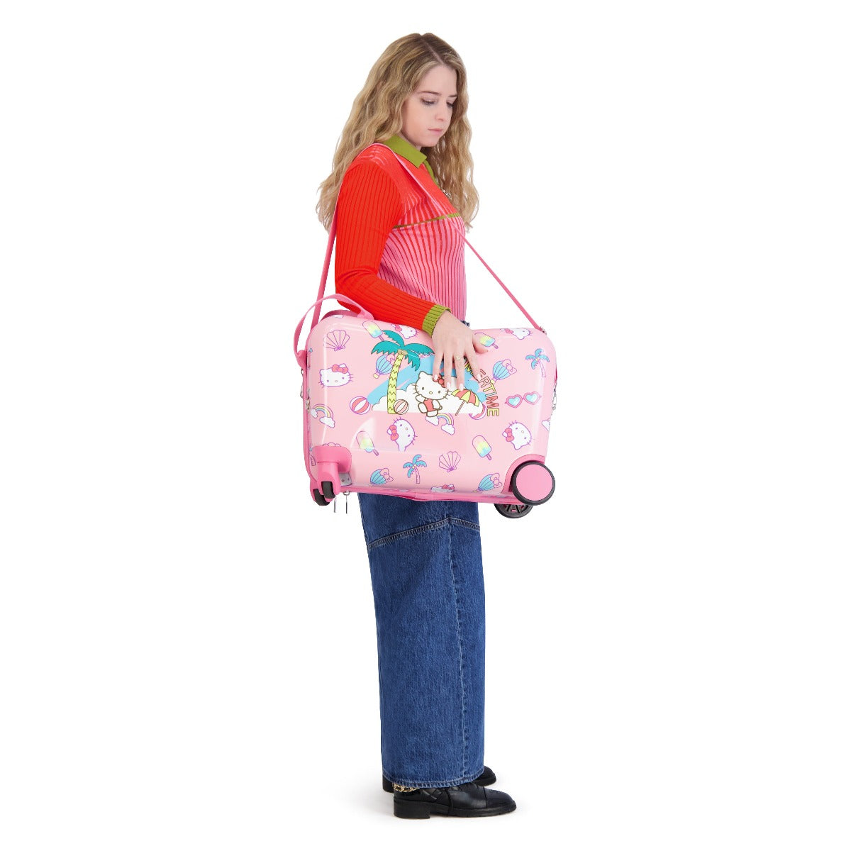 Side view of Hello Kitty luggage showing wheels and footrest for airport mobility
