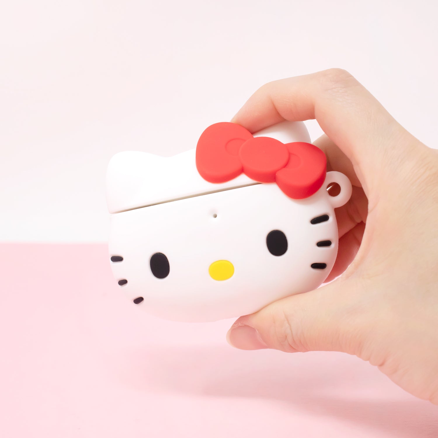 AirPods in the Hello Kitty case being charged wirelessly