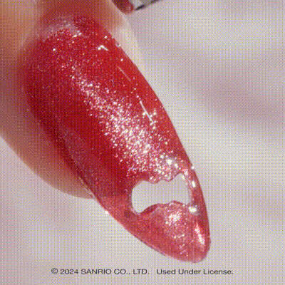 Close-up of sparkly gel polish finish on Hello Kitty nails after using magnet wand