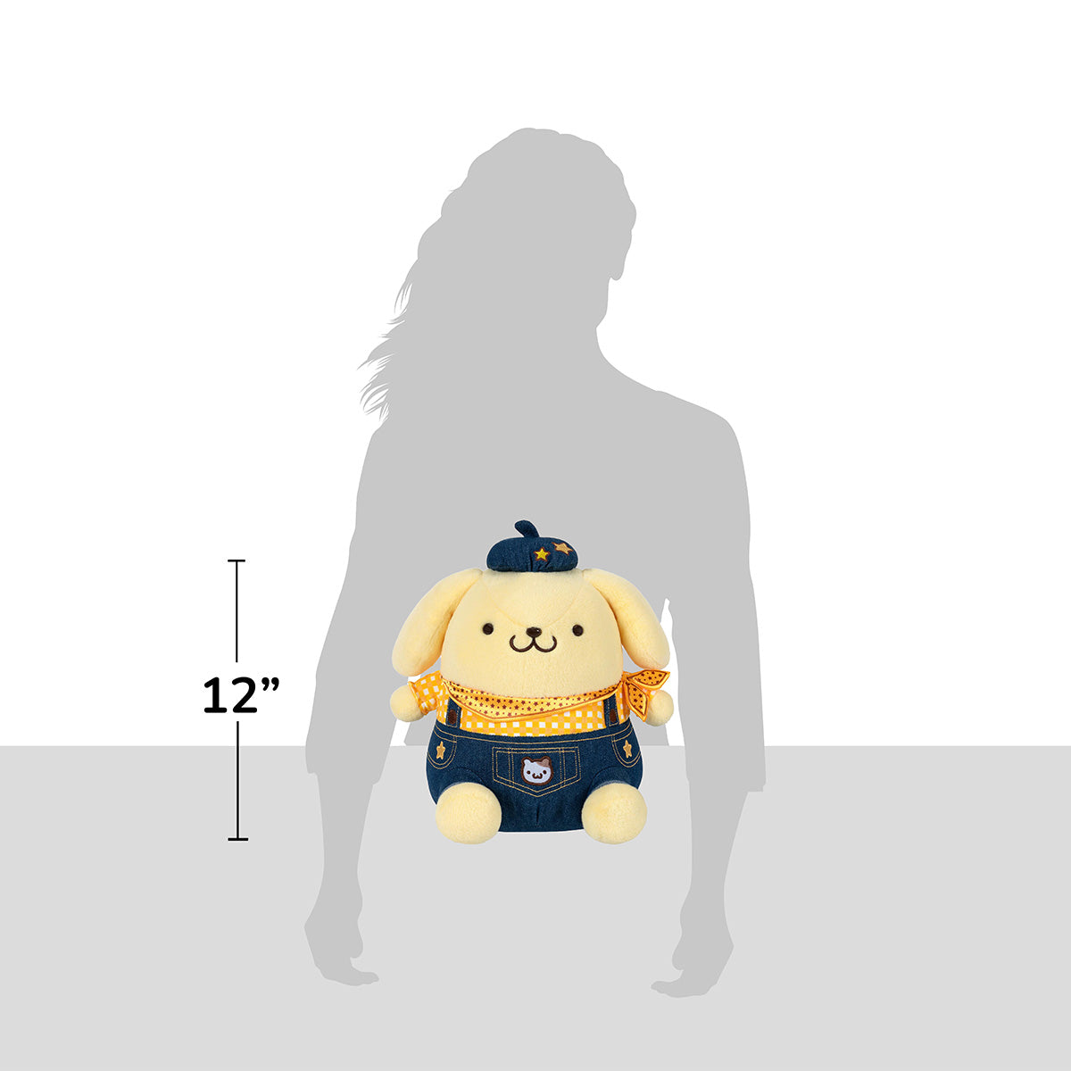 Close-up of Pompompurin plush showing embroidered western outfit details