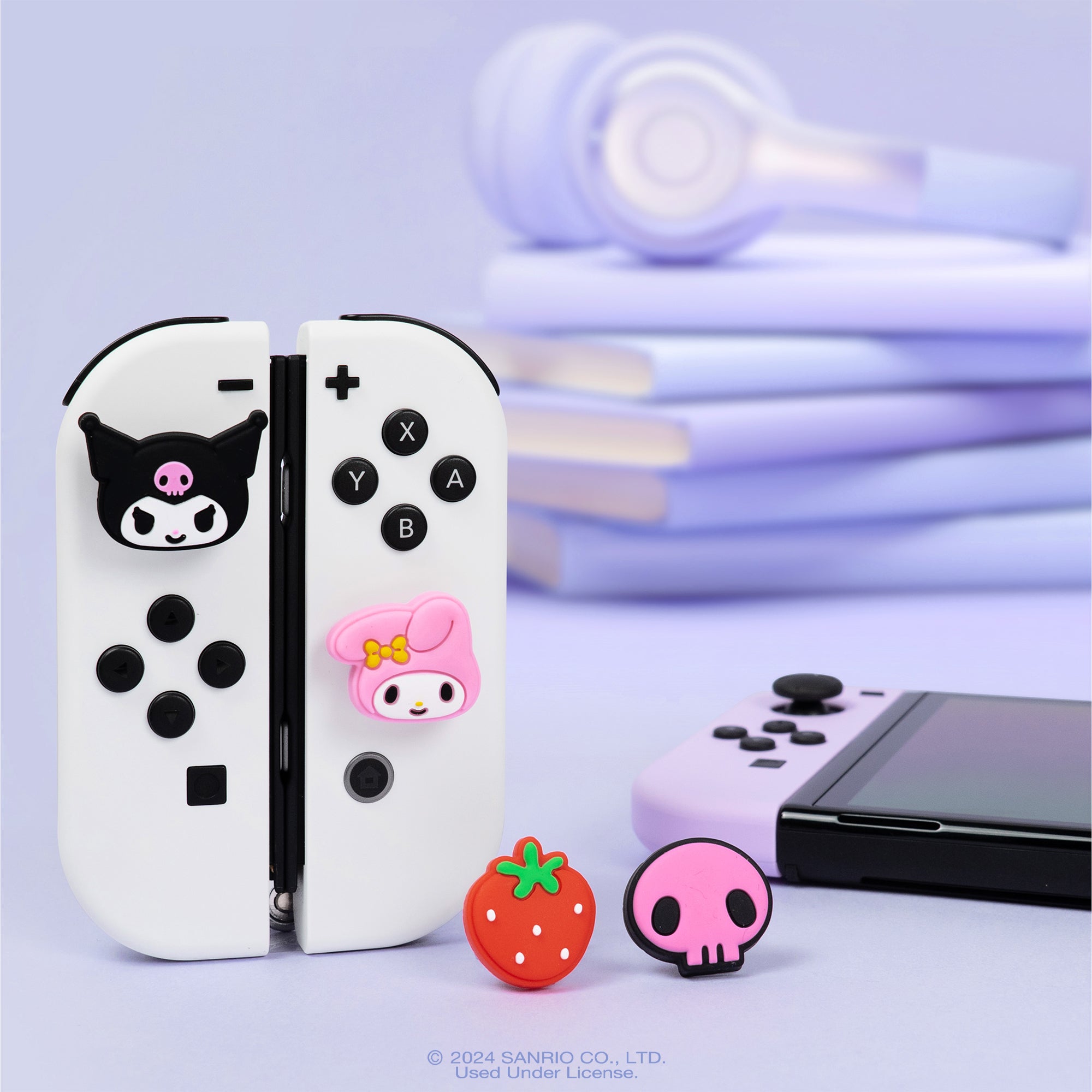 Hello Kitty Kuromi grip cap installed on blue Nintendo Switch Joycon