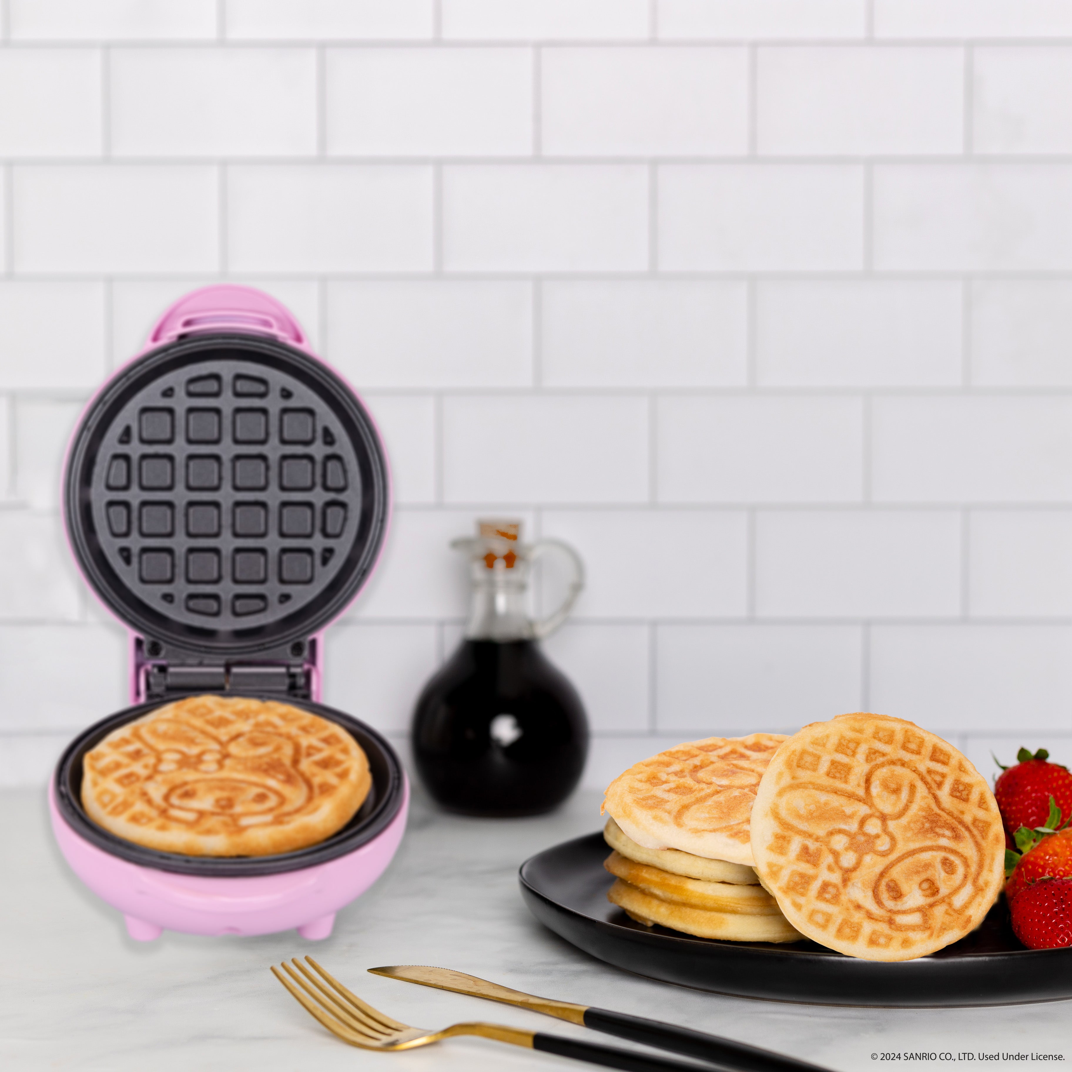 Compact mini waffle maker shown open, highlighting non-stick plates.