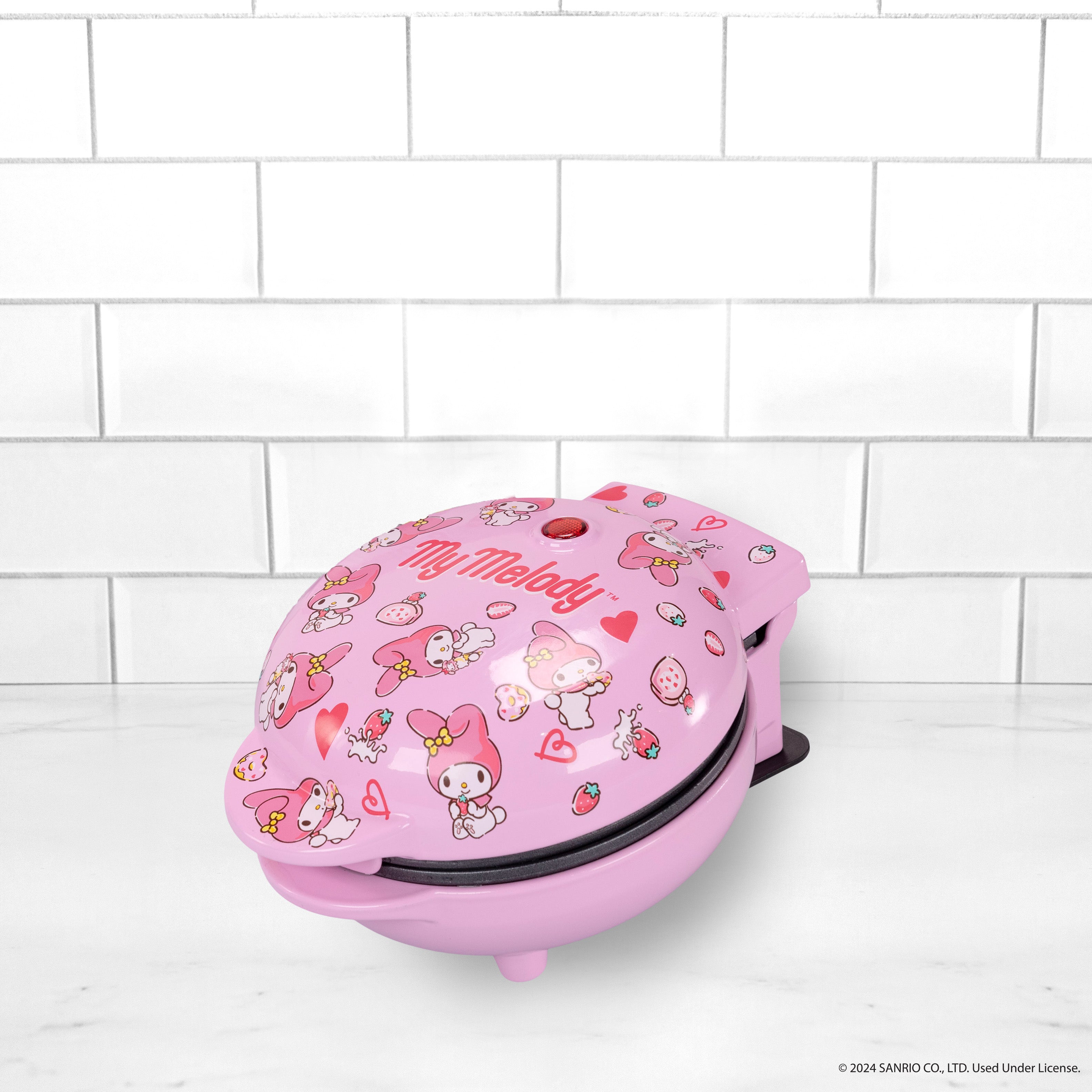 Top-down view of the My Melody mini waffle maker, blush finish and character detailing.