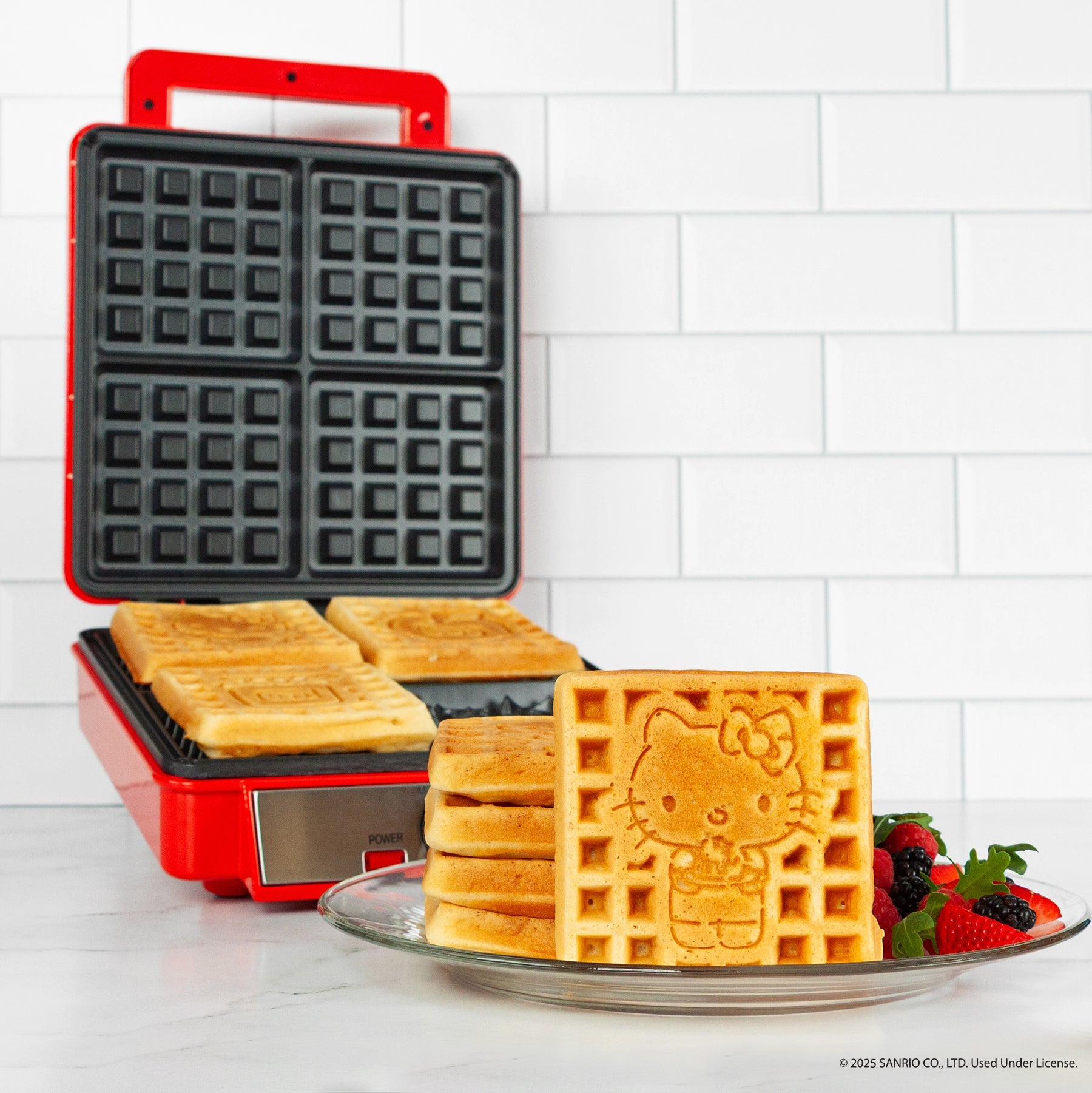 Hello Kitty themed waffle maker with red exterior and character details