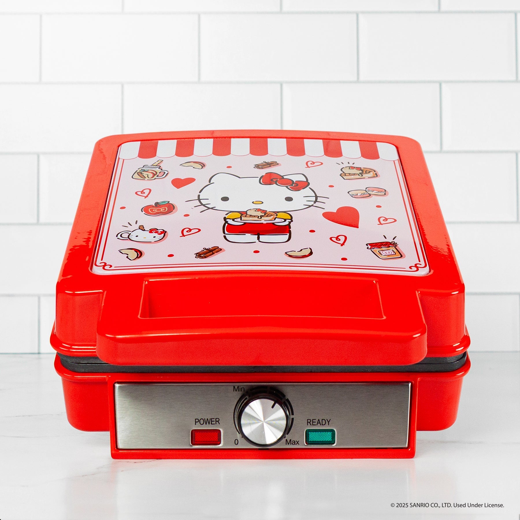 Waffles cooking in the non-stick plates of the Hello Kitty waffle maker