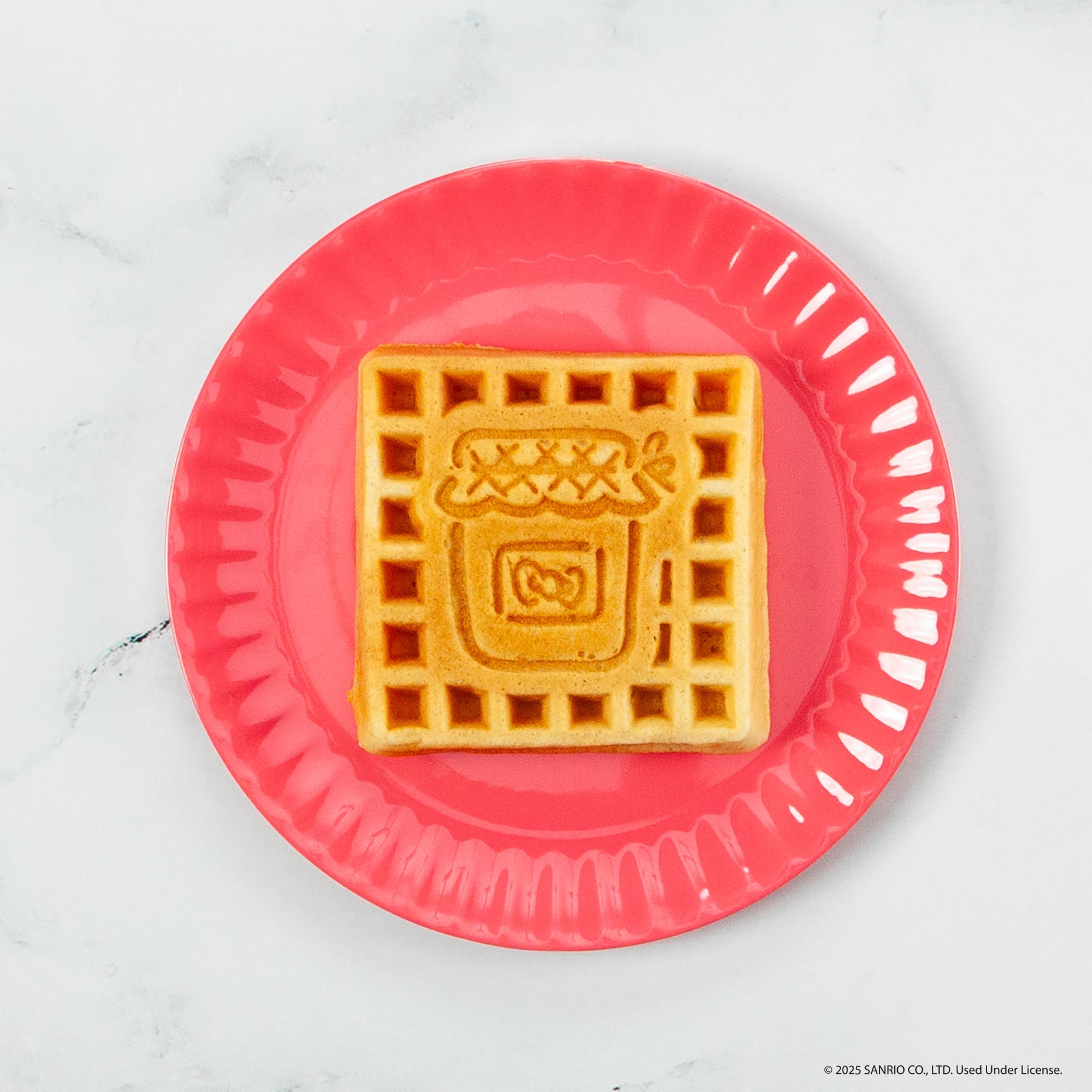 Hello Kitty themed waffle maker with red exterior and character details