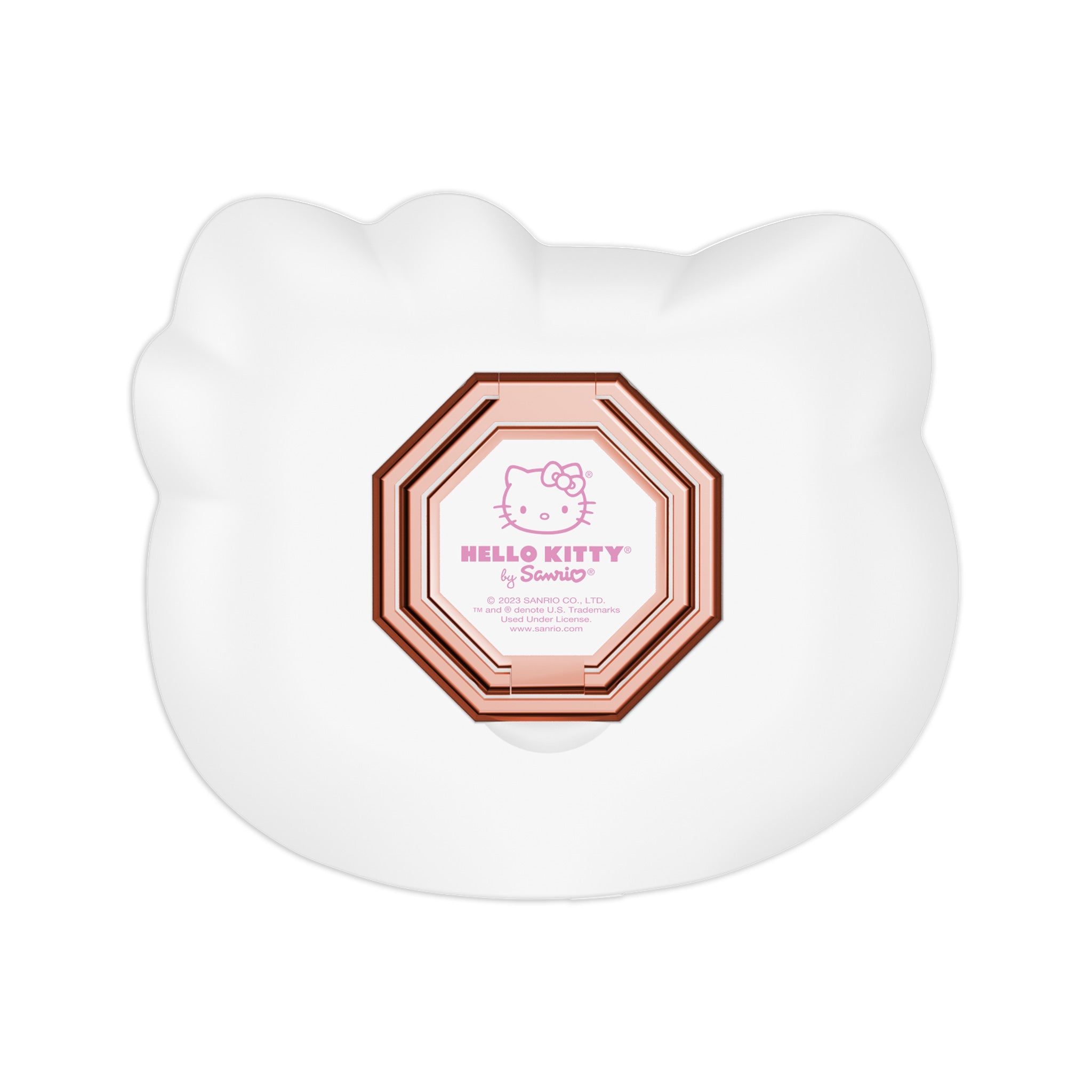 Hello Kitty compact mirror propped up on a vanity table with makeup