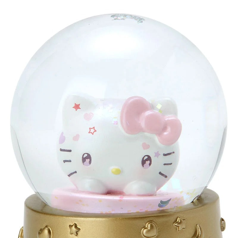 Hello Kitty snow globe being shaken, with snowflakes swirling around the character