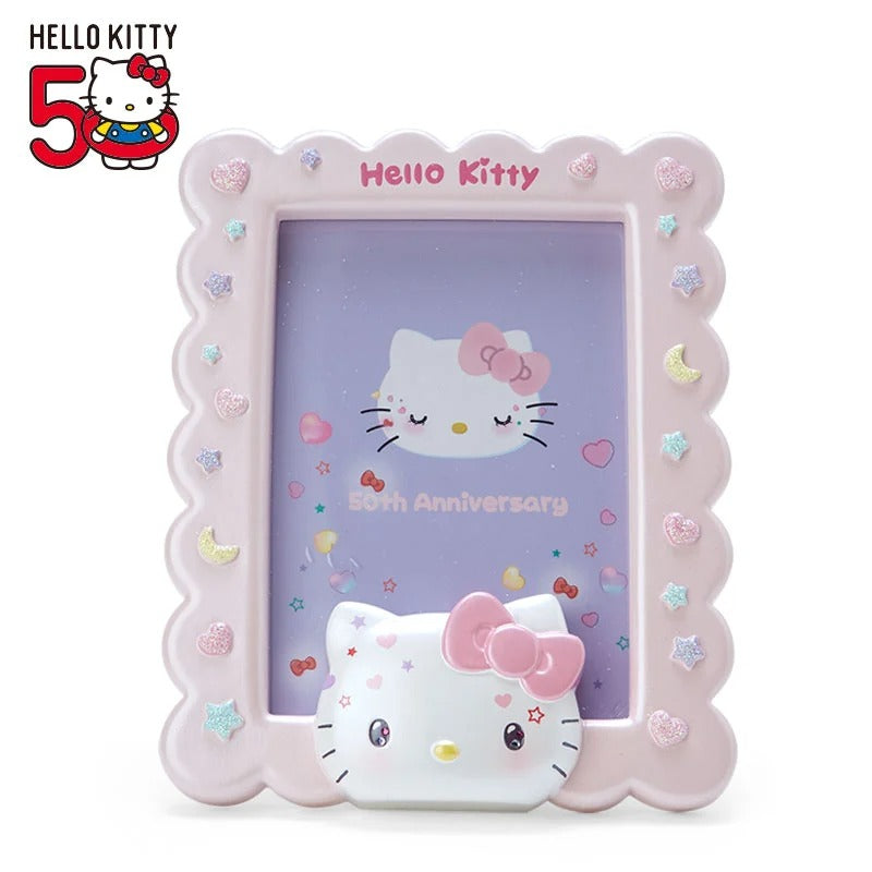 Hello Kitty 50th anniversary photo frame displayed on a shelf with plush toys