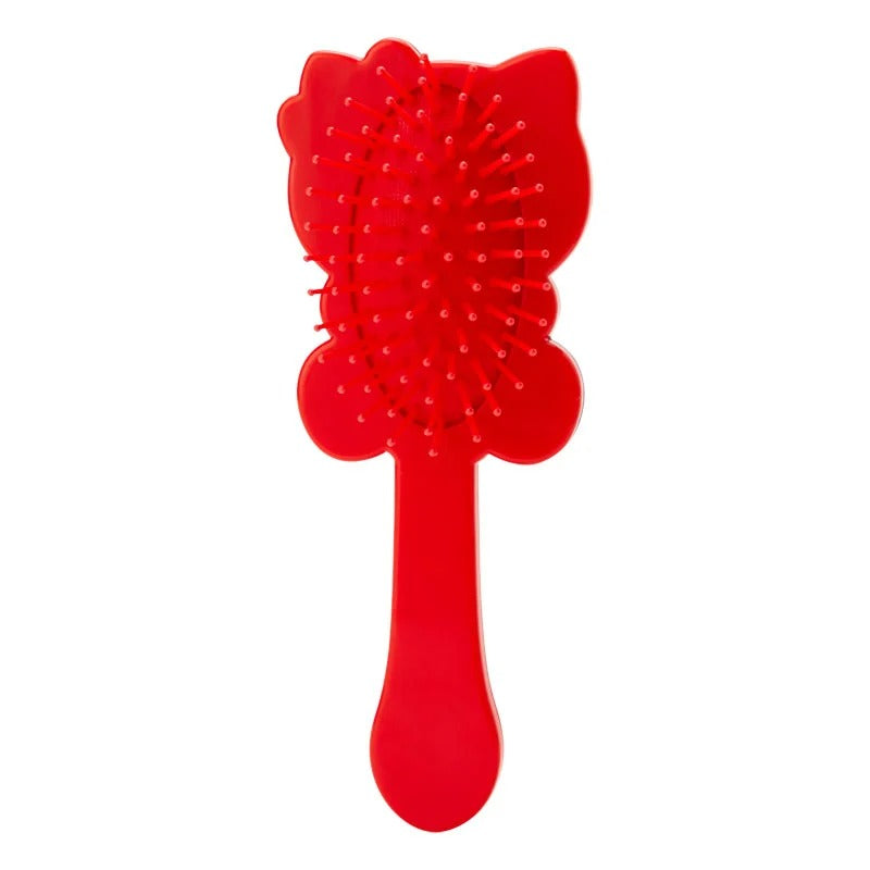 Close-up of the die-cut Tiny Chum design on the portable hairbrush