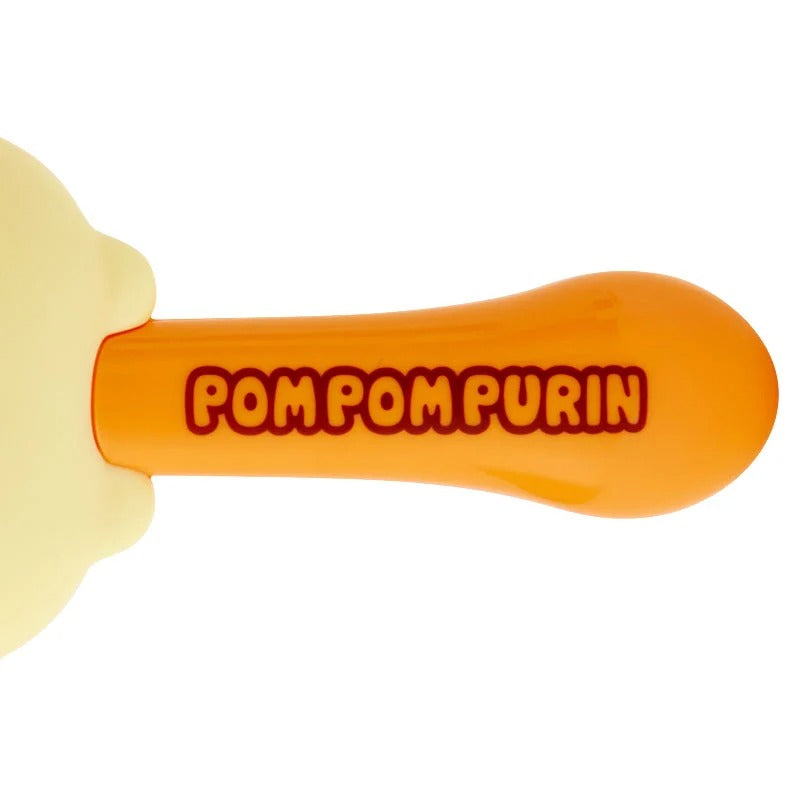 Close-up of Pompompurin character hair brush with signature handle