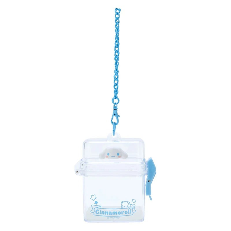 Close-up of the mini companion case with visible Cinnamoroll logo and secure clip.