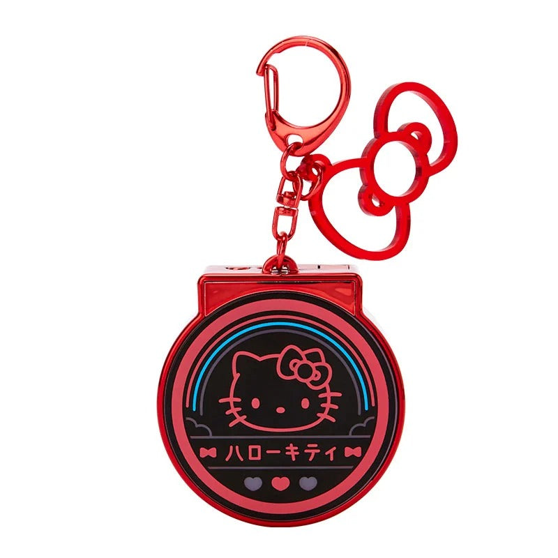 Hello Kitty light-up keychain glowing against a dark background