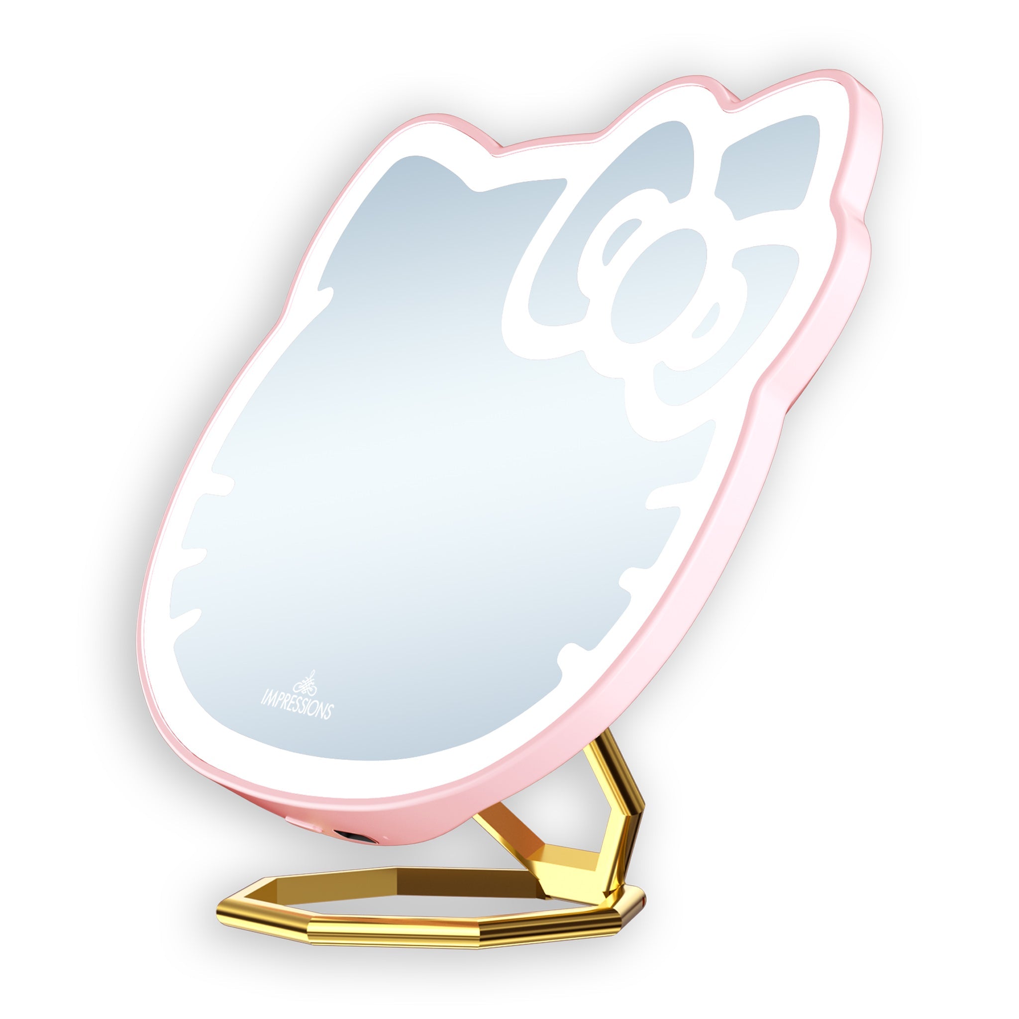 Hello Kitty compact mirror propped up on a vanity table with makeup