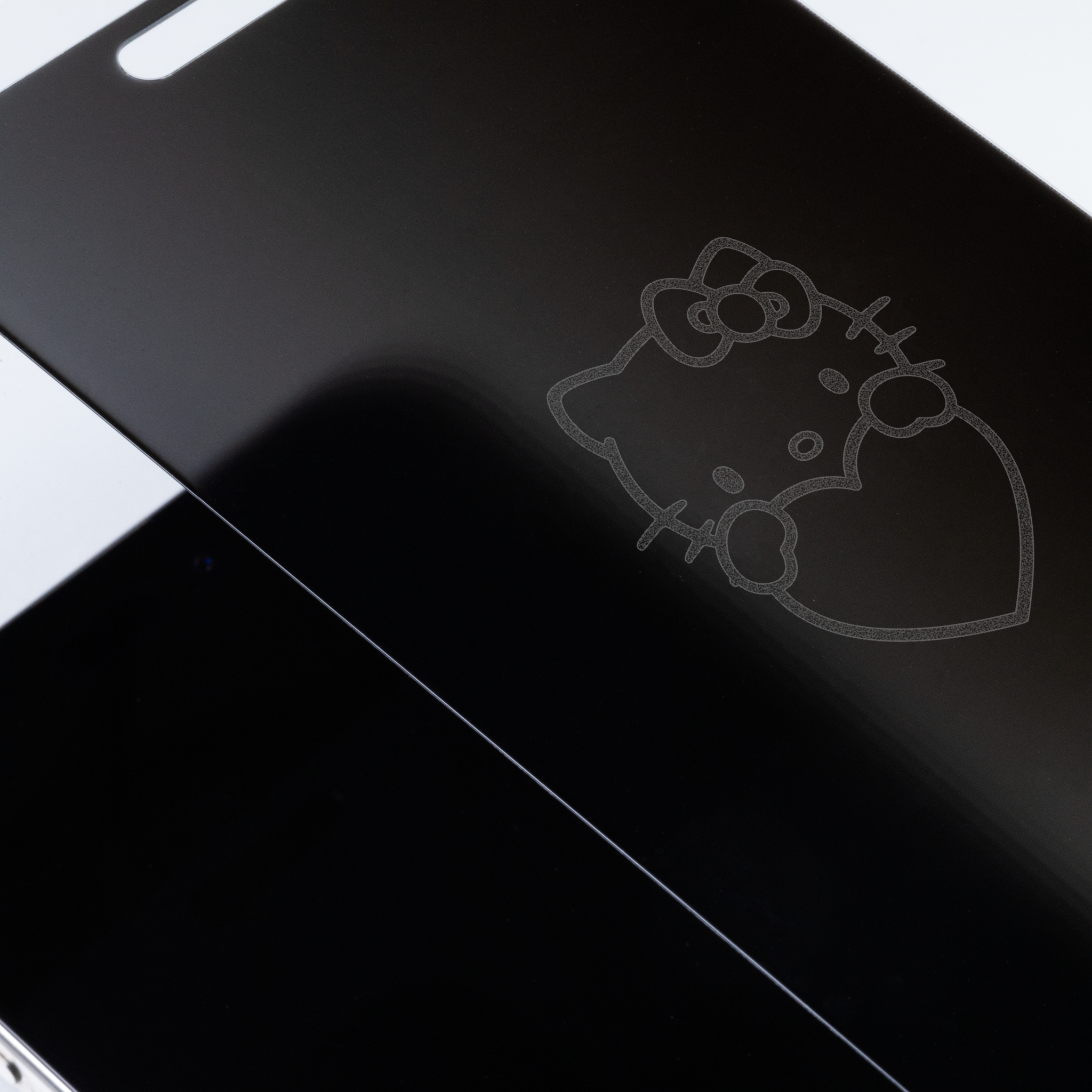 Close-up of tempered glass screen protector with Hands Heart design