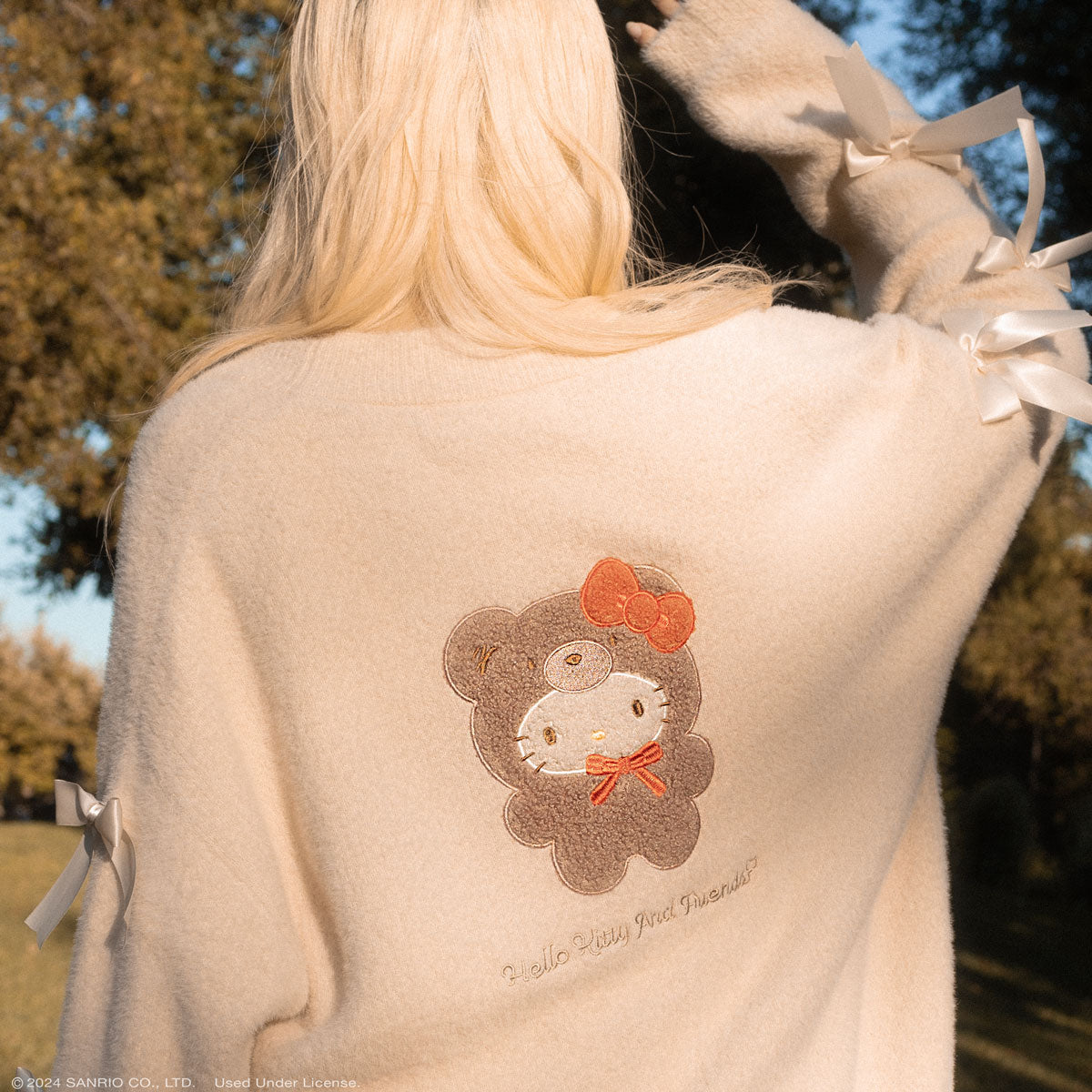 Back view of the Hello Kitty cardigan, highlighting the satin bows on the sleeves