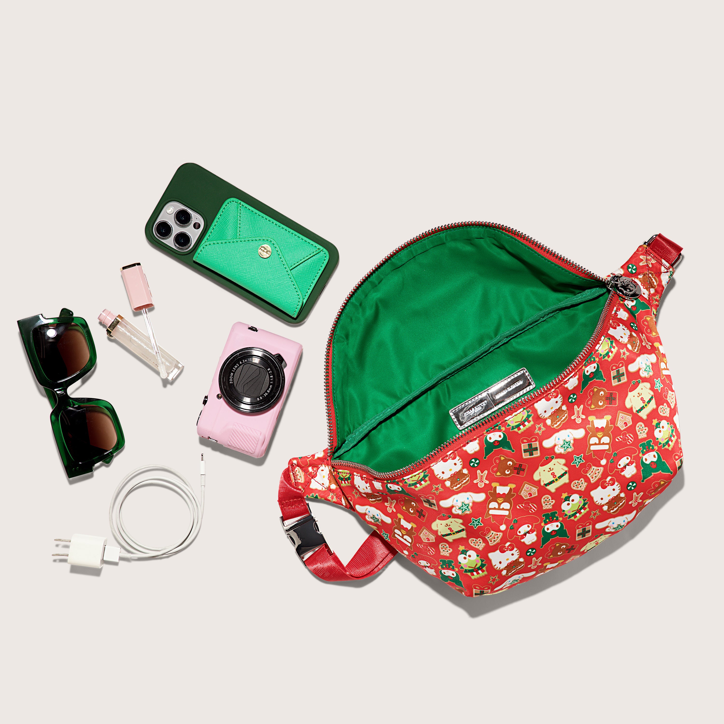 Hello Kitty holiday fanny pack displayed flat with adjustable strap visible