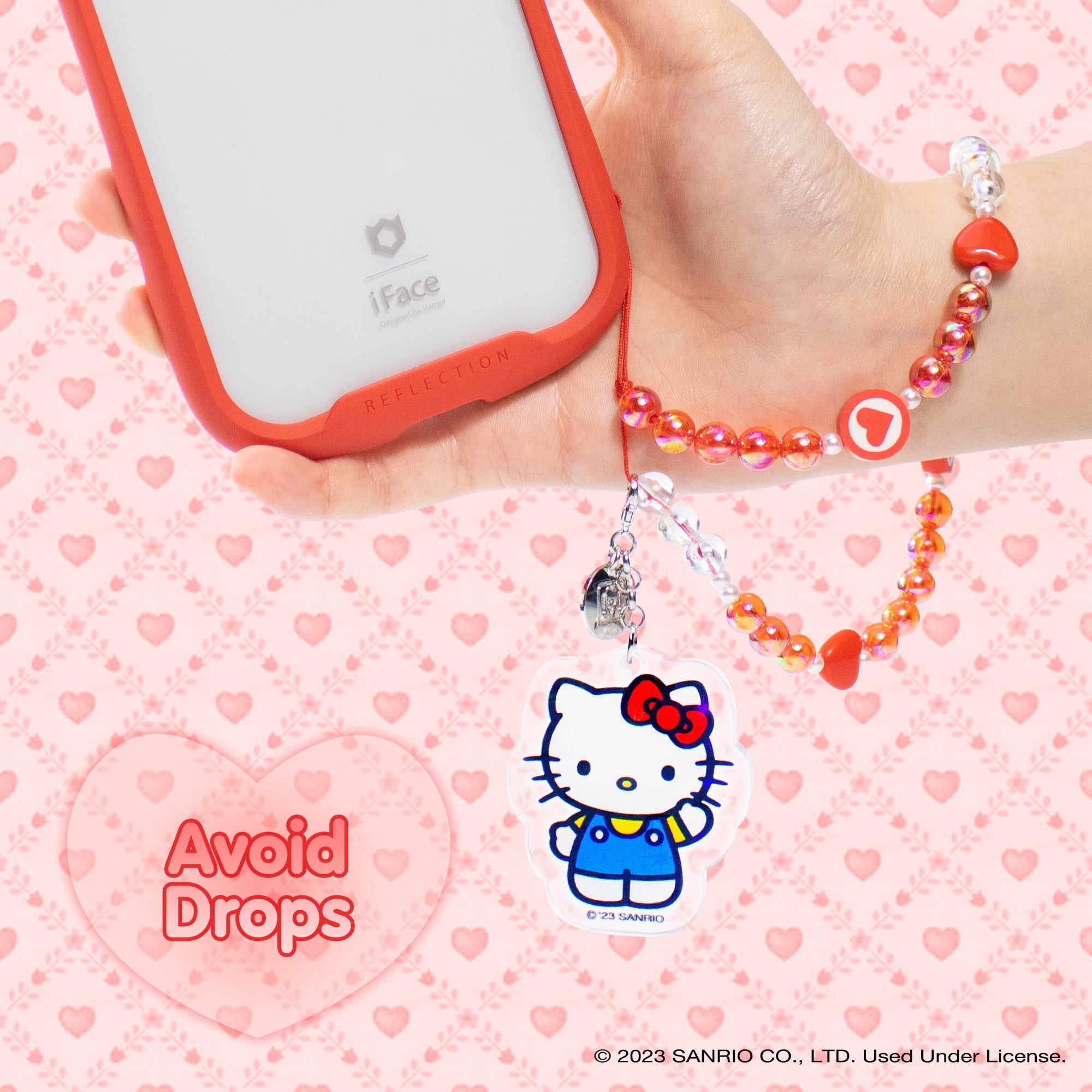 Close-up of the detachable iridescent glitter Hello Kitty charm attached to the beaded strap.