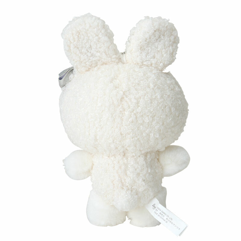 Hello Kitty plush attached to a backpack with the Sanrio bag charm visible