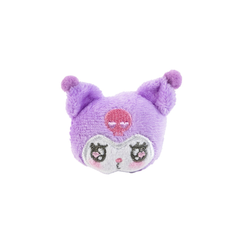 Kuromi plush ring displayed on a wooden desk with other Sanrio-themed accessories.