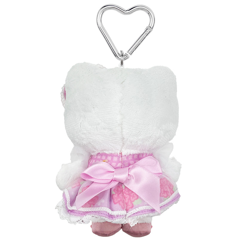Close-up of Hello Kitty plush keychains heart-shaped carabiner and ribbon details.