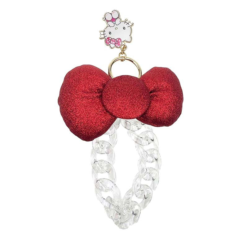 Hello Kitty bag charm attached to a stylish handbag.