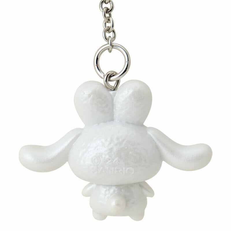 Cinnamoroll Snow Bunny Series bag charm with other Sanrio characters in the background