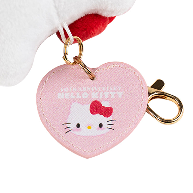 Close-up of embroidered details and heart tag on Hello Kitty plush mascot.
