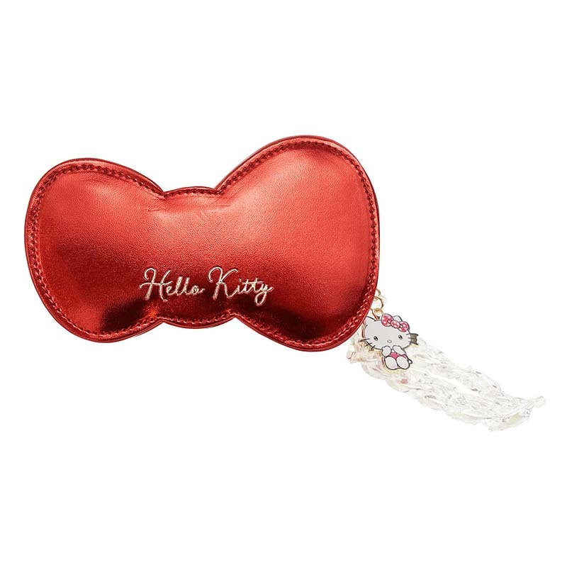 Styled shot of the Hello Kitty zipper wristlet with removable acrylic strap in a casual setting