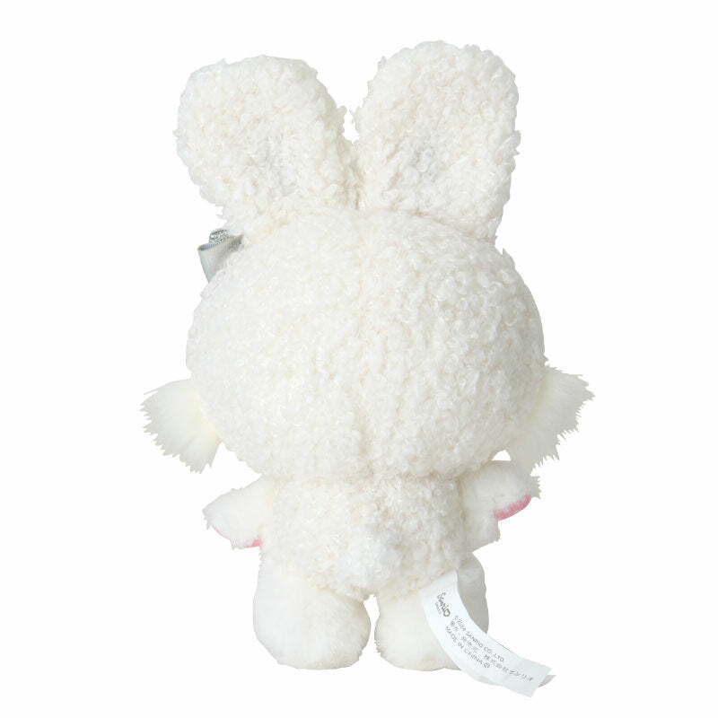 Snow Bunny plush bag charm attached to a winter-themed backpack