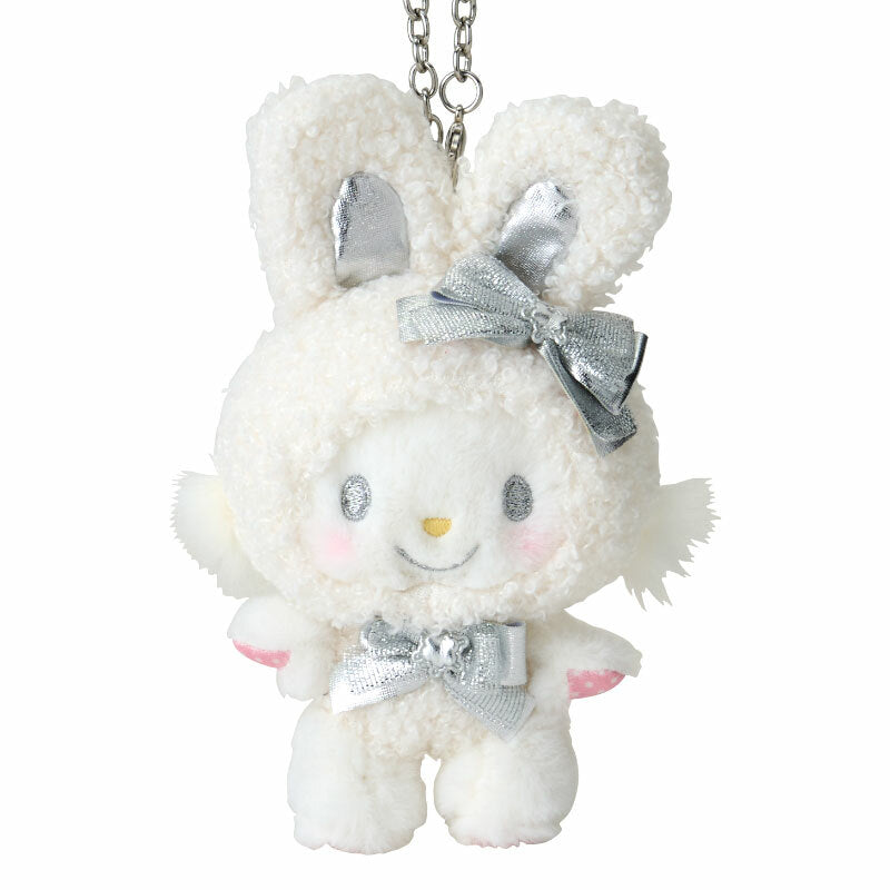 Close-up of the plush bag charms embroidered details and fluffy texture