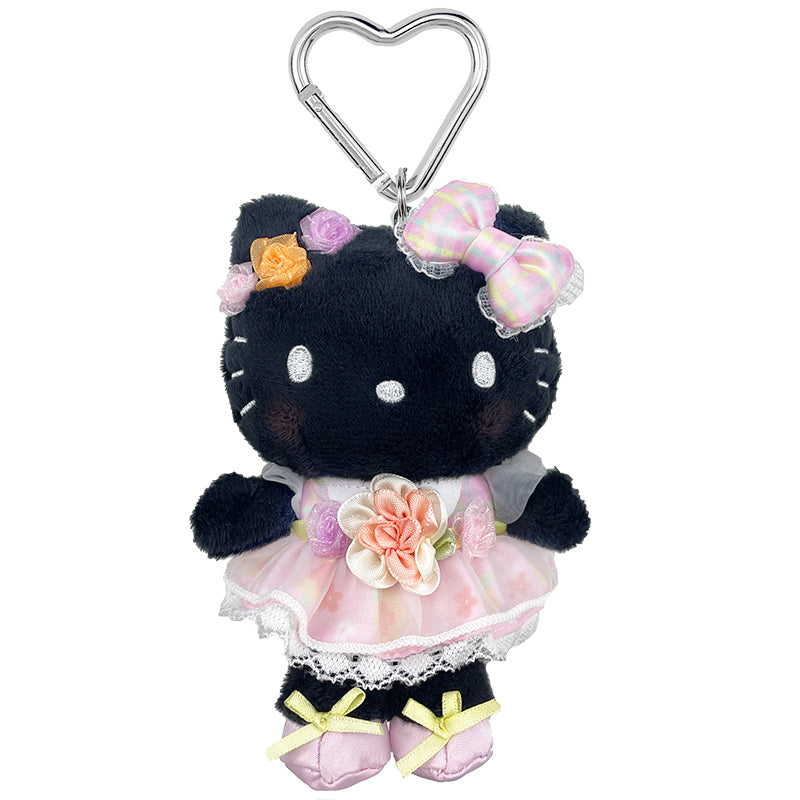 Close-up of Hello Kitty plush keychain with floral dress and heart carabiner.