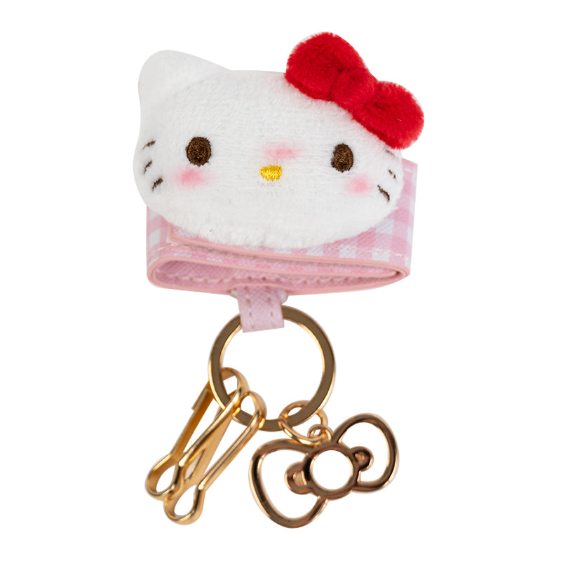 Close-up of Hello Kitty plush keychain with bow and rotary phone design