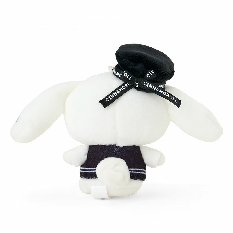 Silver houndstooth Sanrio keychain attached to a designer handbag strap