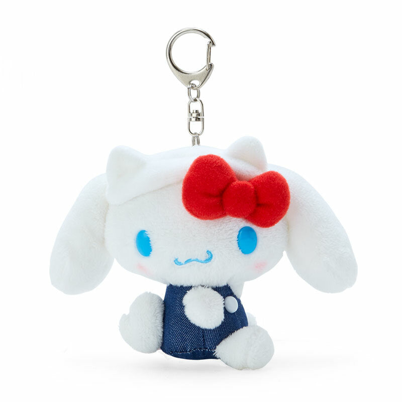Close-up of the plush Cinnamoroll sitting with denim overalls and a headband