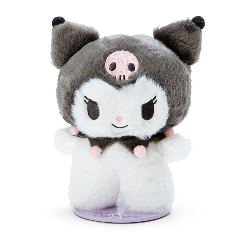 Kuromi plush doll displayed on a bookshelf with a cozy background.
