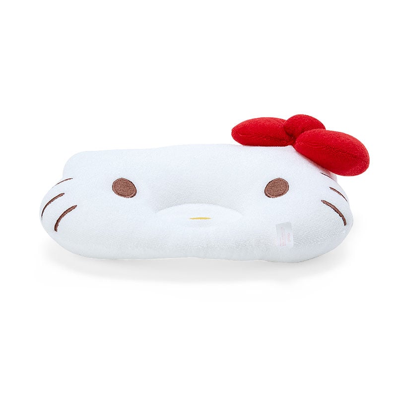 Baby sleeping peacefully with Hello Kitty head support pillow in nursery