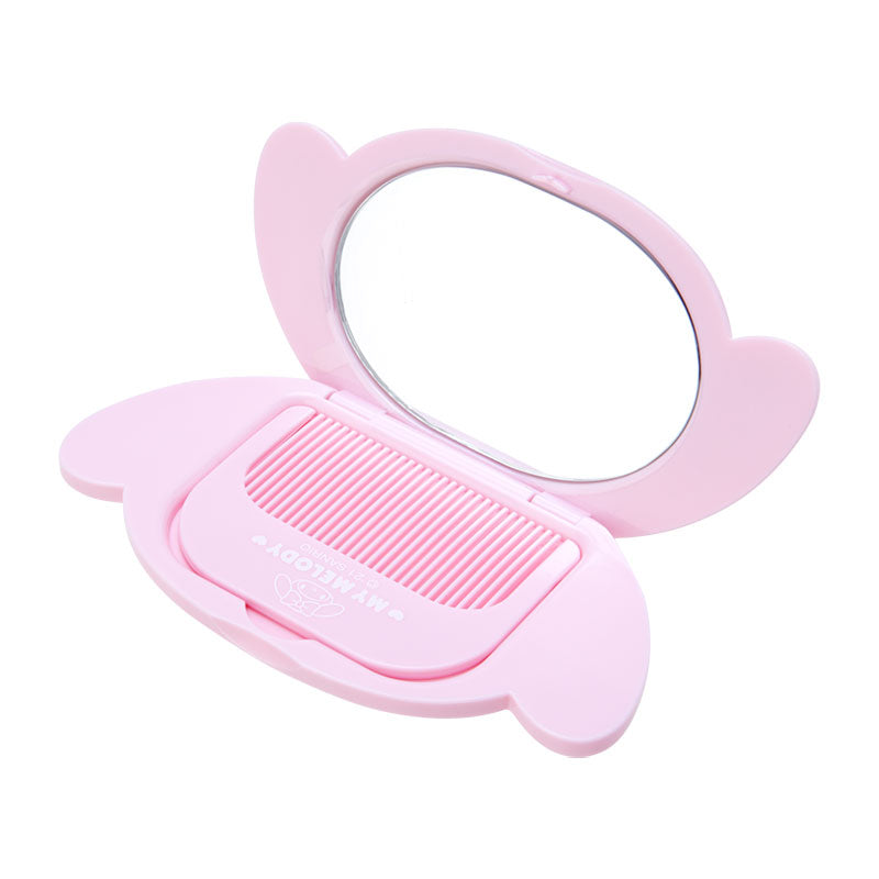 My Melody travel mirror and comb, open and in use